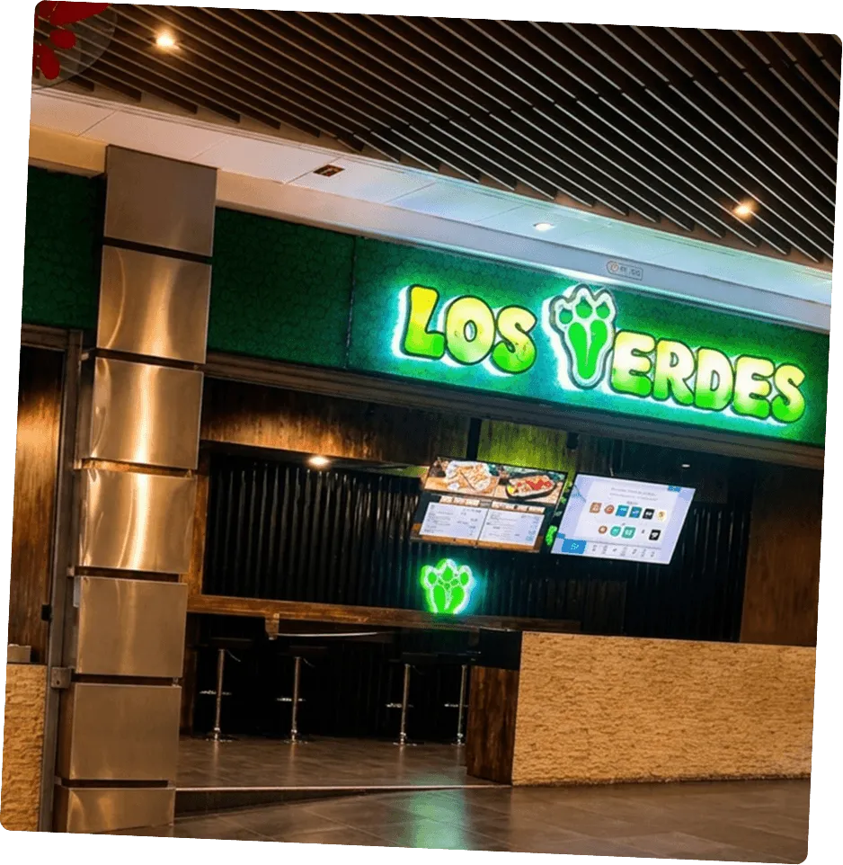 Local Los Verdes con letrero neón y barra de atención